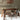 a wooden dining table and chairs in a room with a hanging rattan lampshade
