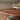 close up of a dining table showing the reclaimed teak wood grain