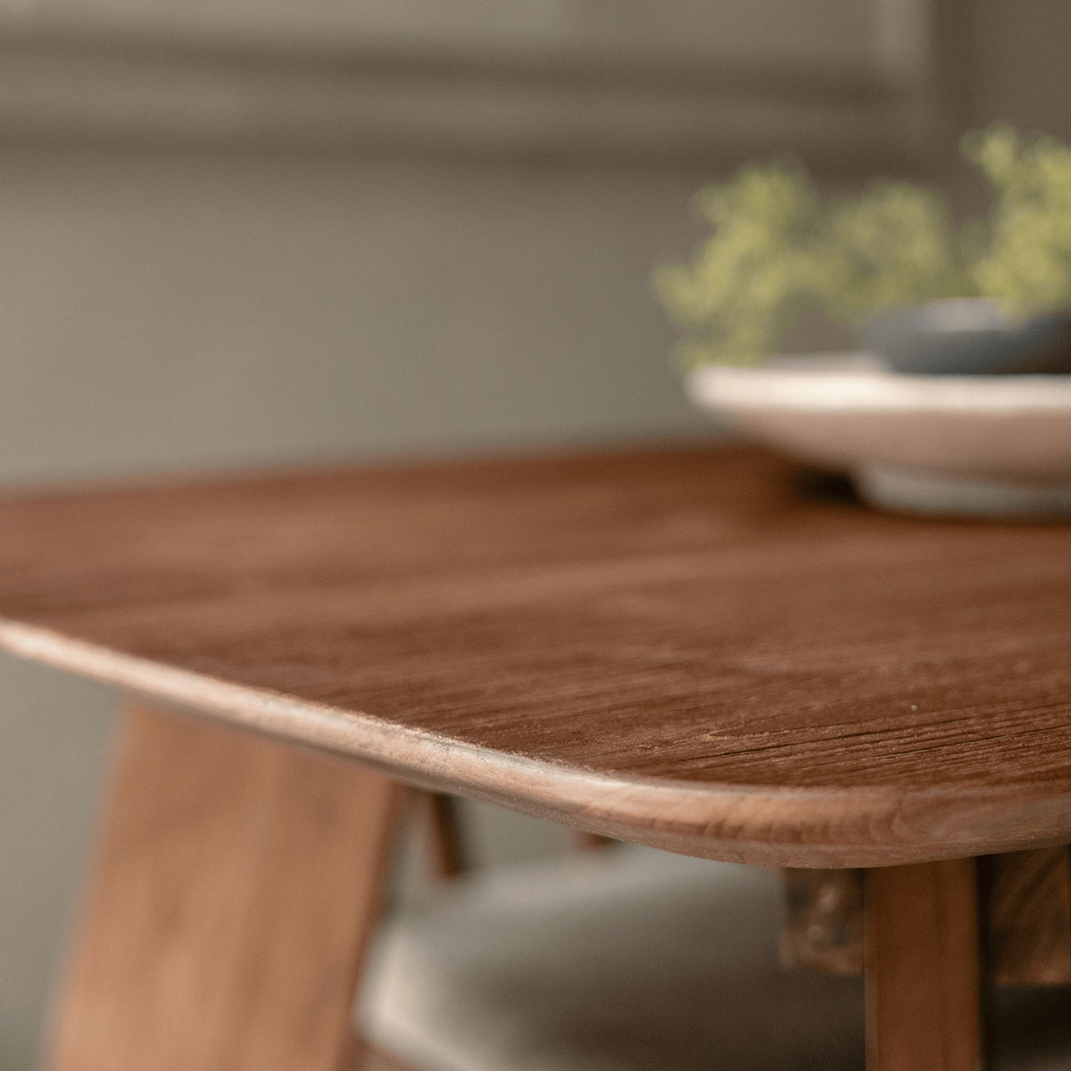 close up of a dining table showing the reclaimed teak wood grain