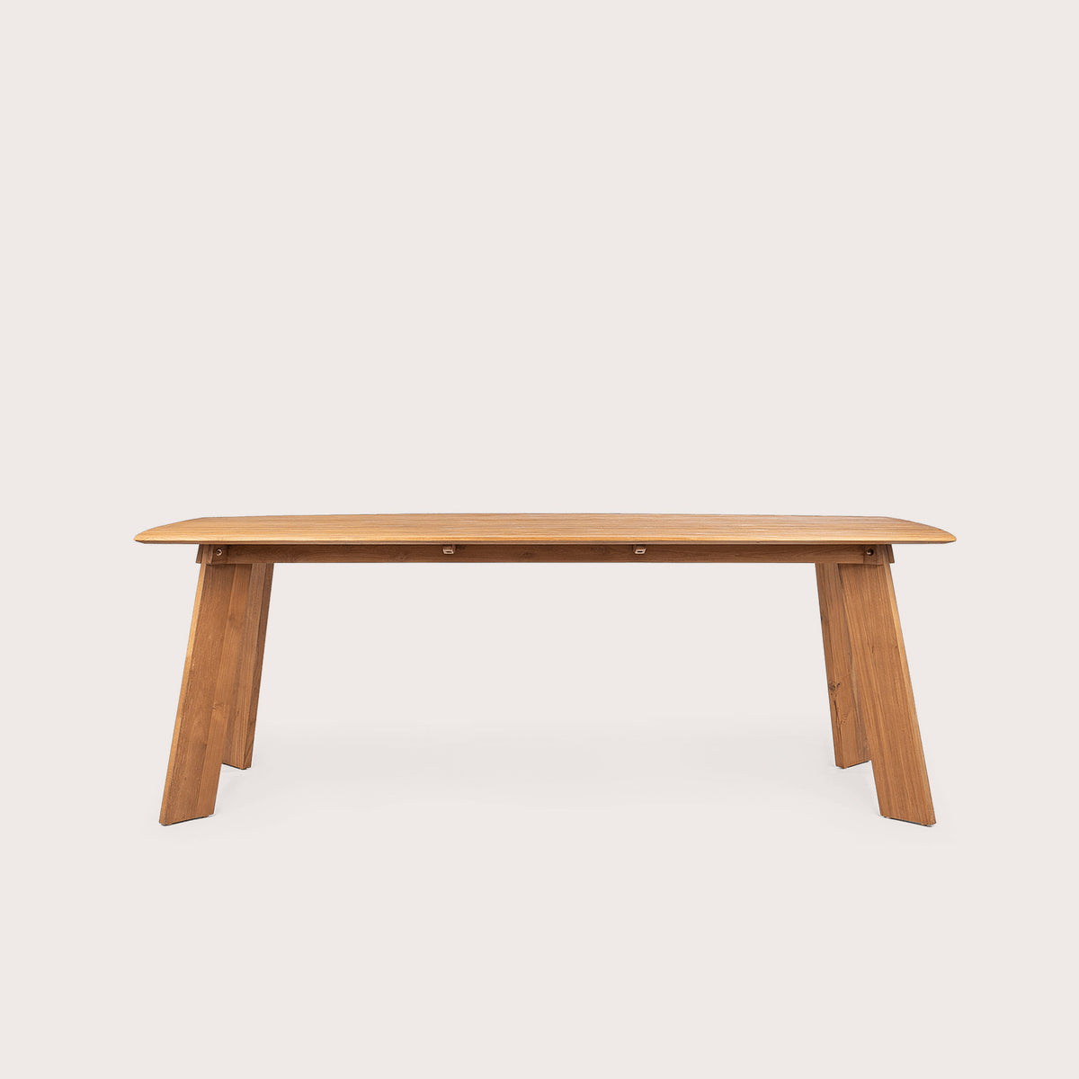 a wooden dining table in reclaimed teak with rounded corner edges